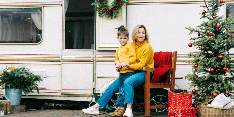 Mother and son sitting outside RV